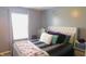 Comfortable bedroom with a tufted headboard, a bright window, and positive energy decor on the wall at 1139 Topp Creek Dr, Indianapolis, IN 46214