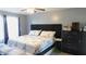 Comfortable bedroom featuring a bed with a tufted headboard, a ceiling fan and a dresser at 1139 Topp Creek Dr, Indianapolis, IN 46214