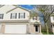 Charming townhome showcasing neutral siding, dark shutters, and an attached garage at 1139 Topp Creek Dr, Indianapolis, IN 46214