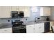 Modern kitchen featuring granite counters, black appliances, and sleek cabinetry for a stylish cooking space at 1139 Topp Creek Dr, Indianapolis, IN 46214