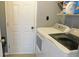 Bright laundry room with white washer and dryer, shelving, and a convenient door at 1139 Topp Creek Dr, Indianapolis, IN 46214