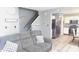 Cozy living room featuring a comfortable gray sofa, a staircase, and an open view into the kitchen at 1139 Topp Creek Dr, Indianapolis, IN 46214