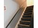 A carpeted staircase with a dark handrail, leading to the upper level of the house at 1139 Topp Creek Dr, Indianapolis, IN 46214