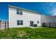 Home's backyard with sliding glass doors, lawn, and fencing at 11629 Brookwood Trace Ln, Indianapolis, IN 46229