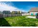 Large backyard with wooden fence, green grass, and view of neighboring houses at 11629 Brookwood Trace Ln, Indianapolis, IN 46229