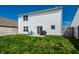 A home's backyard showing the lawn, fencing, and sliding glass doors at 11629 Brookwood Trace Ln, Indianapolis, IN 46229