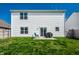 Well-maintained backyard with a small patio, sliding glass door, and grill at 11629 Brookwood Trace Ln, Indianapolis, IN 46229