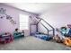 bedroom featuring playful decor, purple walls, and a cozy house bed at 11629 Brookwood Trace Ln, Indianapolis, IN 46229