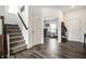 Spacious foyer with staircase, leading to a home office and coat closet, showcasing modern flooring at 11629 Brookwood Trace Ln, Indianapolis, IN 46229