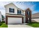 Charming two-story home with attached garage, showcasing a well-maintained lawn and inviting curb appeal at 11629 Brookwood Trace Ln, Indianapolis, IN 46229