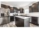 Kitchen with stainless appliances, white counters, dark cabinetry and a center island for prep and cooking at 11629 Brookwood Trace Ln, Indianapolis, IN 46229
