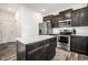 Spacious kitchen boasts stainless appliances, island, dark cabinetry, and is ideal for cooking and entertaining at 11629 Brookwood Trace Ln, Indianapolis, IN 46229