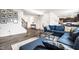 Spacious living room featuring a sectional sofa, staircase, and seamless flow to the kitchen, perfect for entertaining at 11629 Brookwood Trace Ln, Indianapolis, IN 46229