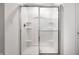 Shower stall features a sliding glass door, built-in shelves, and chrome fixtures for easy cleaning at 11629 Brookwood Trace Ln, Indianapolis, IN 46229