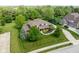 Aerial view of home surrounded by mature trees and perfectly manicured lawn at 13225 Gatman Ct, Carmel, IN 46032