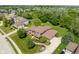 Wide aerial view showcasing a large brick home in a neighborhood setting with mature trees and manicured lawns at 13225 Gatman Ct, Carmel, IN 46032