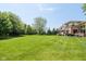 Expansive backyard featuring a well-maintained lawn and mature trees, perfect for outdoor activities and relaxation at 13225 Gatman Ct, Carmel, IN 46032
