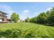 Expansive backyard with lush green lawn and mature trees, perfect for outdoor activities at 13225 Gatman Ct, Carmel, IN 46032