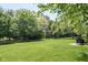 Lush green backyard featuring mature trees, offering a serene and private outdoor space at 13225 Gatman Ct, Carmel, IN 46032