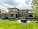 Paver patio with comfortable seating, grill, and hot tub, perfect for outdoor living at 13225 Gatman Ct, Carmel, IN 46032