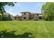 The expansive lawn of the home with outdoor entertaining area, hot tub, and lush green landscaping at 13225 Gatman Ct, Carmel, IN 46032