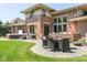 Beautiful backyard featuring a patio dining set, a hot tub, and lush green space, perfect for outdoor enjoyment at 13225 Gatman Ct, Carmel, IN 46032