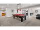 Basement with a pool table, bar, and a seating area at 13225 Gatman Ct, Carmel, IN 46032