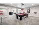 Finished basement with pool table, bar, and comfortable seating area at 13225 Gatman Ct, Carmel, IN 46032