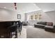 Cozy finished basement featuring a wet bar with seating and a comfortable lounge area with large windows at 13225 Gatman Ct, Carmel, IN 46032