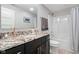 Modern bathroom with granite countertop, a large mirror, and a shower-tub combo for comfort and style at 13225 Gatman Ct, Carmel, IN 46032