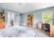 Bright bedroom with blue walls, a bookshelf, a desk, and a view from the window at 13225 Gatman Ct, Carmel, IN 46032