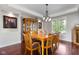 Bright dining room with hardwood floors, large window with backyard view, and seating for six at 13225 Gatman Ct, Carmel, IN 46032