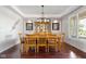 Dining room with tray ceiling, hardwood floors, and furniture with seating for eight at 13225 Gatman Ct, Carmel, IN 46032