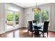 Bright dining room with stylish lighting, access to the backyard, and hardwood floors at 13225 Gatman Ct, Carmel, IN 46032