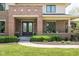 Inviting entryway with double front doors, manicured bushes, and a covered porch that enhances the home's curb appeal at 13225 Gatman Ct, Carmel, IN 46032
