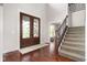 Grand foyer featuring a staircase, hardwood floors, and a stunning front door that welcomes guests with elegance and style at 13225 Gatman Ct, Carmel, IN 46032