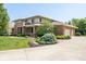 Two story brick home with manicured landscaping, a circular driveway, and an attached two-car garage at 13225 Gatman Ct, Carmel, IN 46032