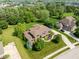 Beautiful two-story brick home with lush green lawn and mature trees at 13225 Gatman Ct, Carmel, IN 46032