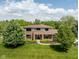 Aerial view of a two story brick home with mature landscaping, large front yard, and a charming walkway leading to the front door at 13225 Gatman Ct, Carmel, IN 46032