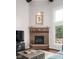 Living room showcasing a brick fireplace, large windows, and hardwood floors at 13225 Gatman Ct, Carmel, IN 46032