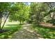 Scenic view of gravel path winding through well-maintained trees and lawn at 13225 Gatman Ct, Carmel, IN 46032