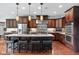 Gourmet kitchen with dark wood cabinets, a granite countertop island, and stainless steel appliances at 13225 Gatman Ct, Carmel, IN 46032