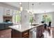 Kitchen featuring island, stainless steel appliances and view to the fireplace and dining area at 13225 Gatman Ct, Carmel, IN 46032