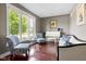 Cozy living room with large windows, hardwood floors, and comfortable furniture at 13225 Gatman Ct, Carmel, IN 46032