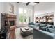 Spacious living room with a brick fireplace, large windows, and comfortable seating, perfect for entertaining and relaxation at 13225 Gatman Ct, Carmel, IN 46032