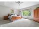 Spacious main bedroom with a ceiling fan, carpet floors, and natural light from a large window at 13225 Gatman Ct, Carmel, IN 46032