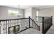 Open staircase with decorative railing and natural light at 13225 Gatman Ct, Carmel, IN 46032