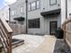 Landscaped backyard with stone patio, wooden fence, modern siding, and integrated outdoor grill at 1326 E 10Th St, Indianapolis, IN 46202