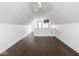 Spacious bonus room featuring hardwood floors and modern lighting under an exposed sloped ceiling at 1326 E 10Th St, Indianapolis, IN 46202