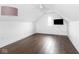 This bonus room boasts gorgeous hardwood floors, a ceiling fan, and natural light from the window at 1326 E 10Th St, Indianapolis, IN 46202